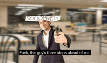 a man in a suit points a gun at someone with a sign on his head that says sociopathy