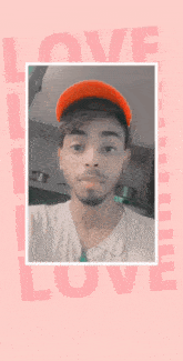 a man wearing a red hat is standing in front of a pink background with the word love on it