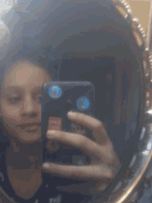a person taking a picture of themselves in a mirror with stickers on their phone including one that says " once upon "