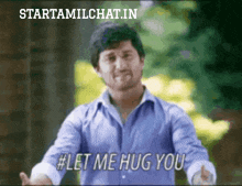 a man in a blue shirt is giving a hug and says let me hug you
