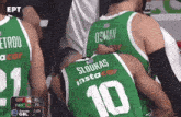a group of basketball players are huddled together and one has the number 10 on his back