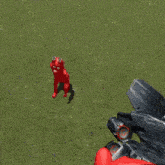 a video game character is holding a gun in a grassy field