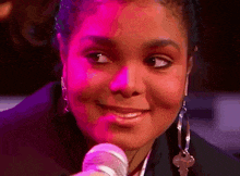 a close up of a woman 's face with a microphone