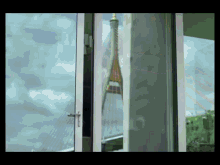 a window with a view of a bridge and a building