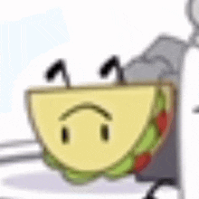 a slice of taco with a sad face on it is sitting on a table .