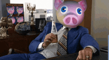a man in a blue suit has a pig mask on his face