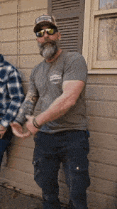 a man with a beard is wearing a shirt that says comfort guaranteed