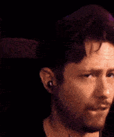 a close up of a man 's face with a beard making a funny face .