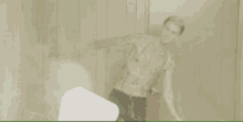 a man in a pink shirt kicking another man in the face