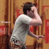 a painting of a man covering his face with his hand and a viggle.ai logo in the corner