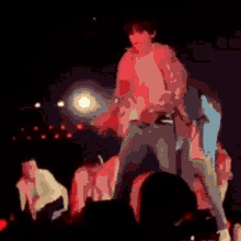 a blurry picture of a group of people dancing in a dark room