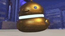 a golden rubber duck with a white collar and a blue eye