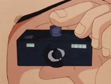 a close up of a person holding a camera with the letter c on the lens