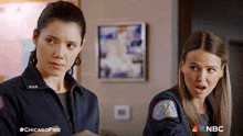 two female firefighters standing next to each other with a nbc logo in the corner