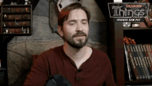 a man in front of a sign that says dragons things