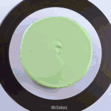 a cake with green frosting and the word mr. cakes on the bottom