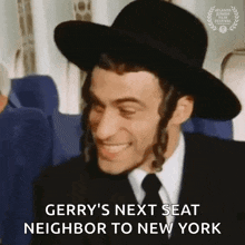 a man wearing a hat and tie is smiling while sitting on a plane .