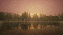 a sunset over a lake with trees in the distance