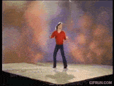roger voudouris is dancing on a stage in a video