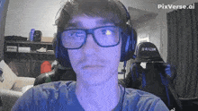 a man wearing glasses and headphones with the word racer on the back of his chair