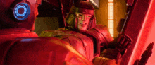 a robot is sitting in a red room with a red light behind it .