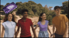 a group of young people holding hands while a purple phone flies in the air