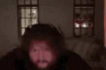 a blurry picture of a man 's face in a dark room