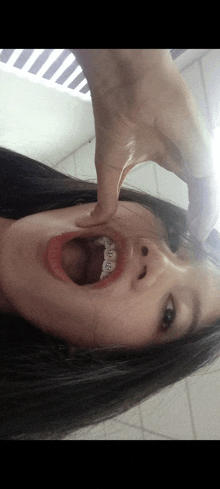 a girl with braces on her teeth is taking a picture