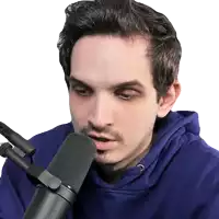 a man wearing a purple hoodie is talking into a microphone