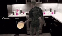 a person is standing in a kitchen holding a pan .