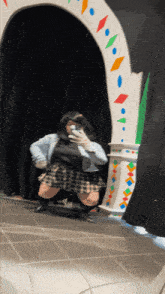 a woman is taking a selfie in front of a mirror