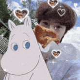 a girl is holding a pretzel in front of a cartoon character