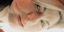 a close up of a woman 's face with a reflection in the mirror .