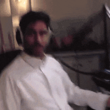 a man wearing headphones and a white shirt