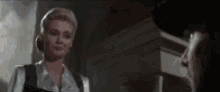a man and a woman are talking to each other in a room .