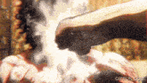 a close up of a person 's fist with a gifrun.com logo in the corner