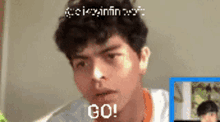 a man with curly hair is making a funny face and says go !