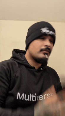 a man wearing a black hoodie that says multiverse