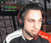 a man wearing headphones and a shirt that says frags