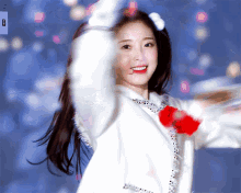 a blurry picture of a girl with a white jacket and a red bow in her hair