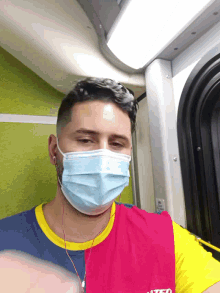 a man wearing a face mask and a shirt that says ' a ' on the front