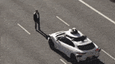 a white car with a black object on the top of it
