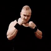 a man in a black tank top is surrounded by fire
