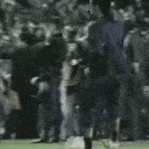 a soccer player is kicking a ball on a field