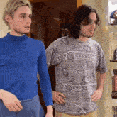 two men are standing next to each other one wearing a shirt that says ' gucci ' on it