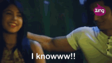 a man holds a woman 's shoulder and says i knowwww