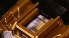 a close up of a gold object that says ' aa ' on it