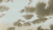 a red balloon is floating in the sky with clouds