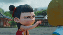 a little girl is holding a knife and making a funny face .