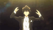 a man in a tuxedo and bow tie is holding his hands up in the air